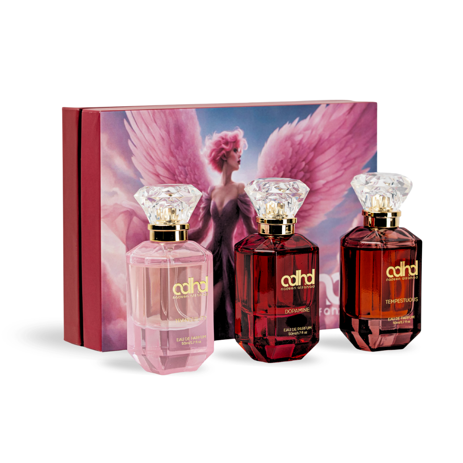 Three colored bottles with diamond shape caps in front of a rectangular box with the image of an angel with pink wings