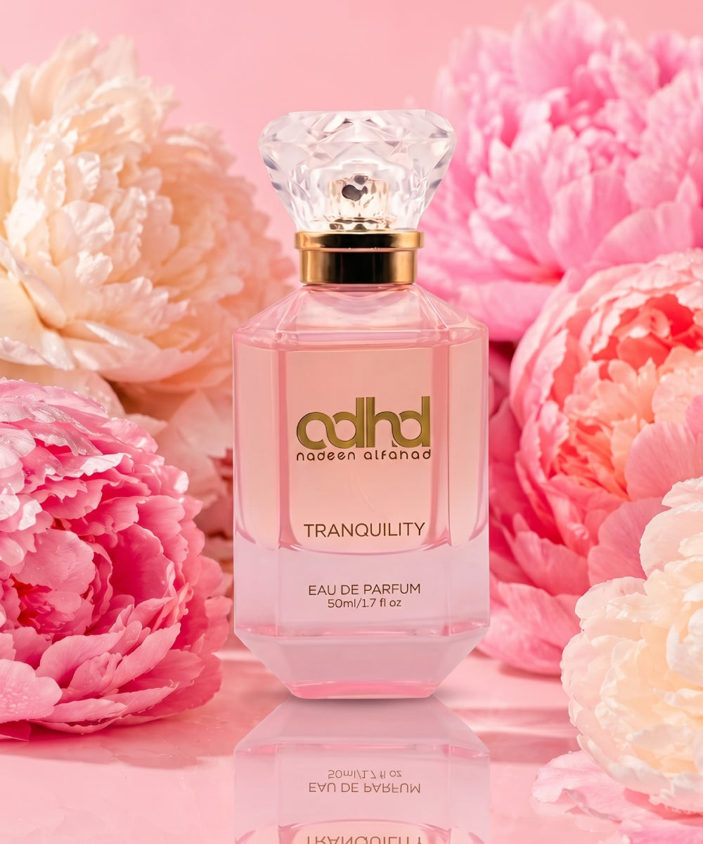 Pink colored perfume bottle with a diamond shape cap. In golden letters it reads "ADHD Tranquility"